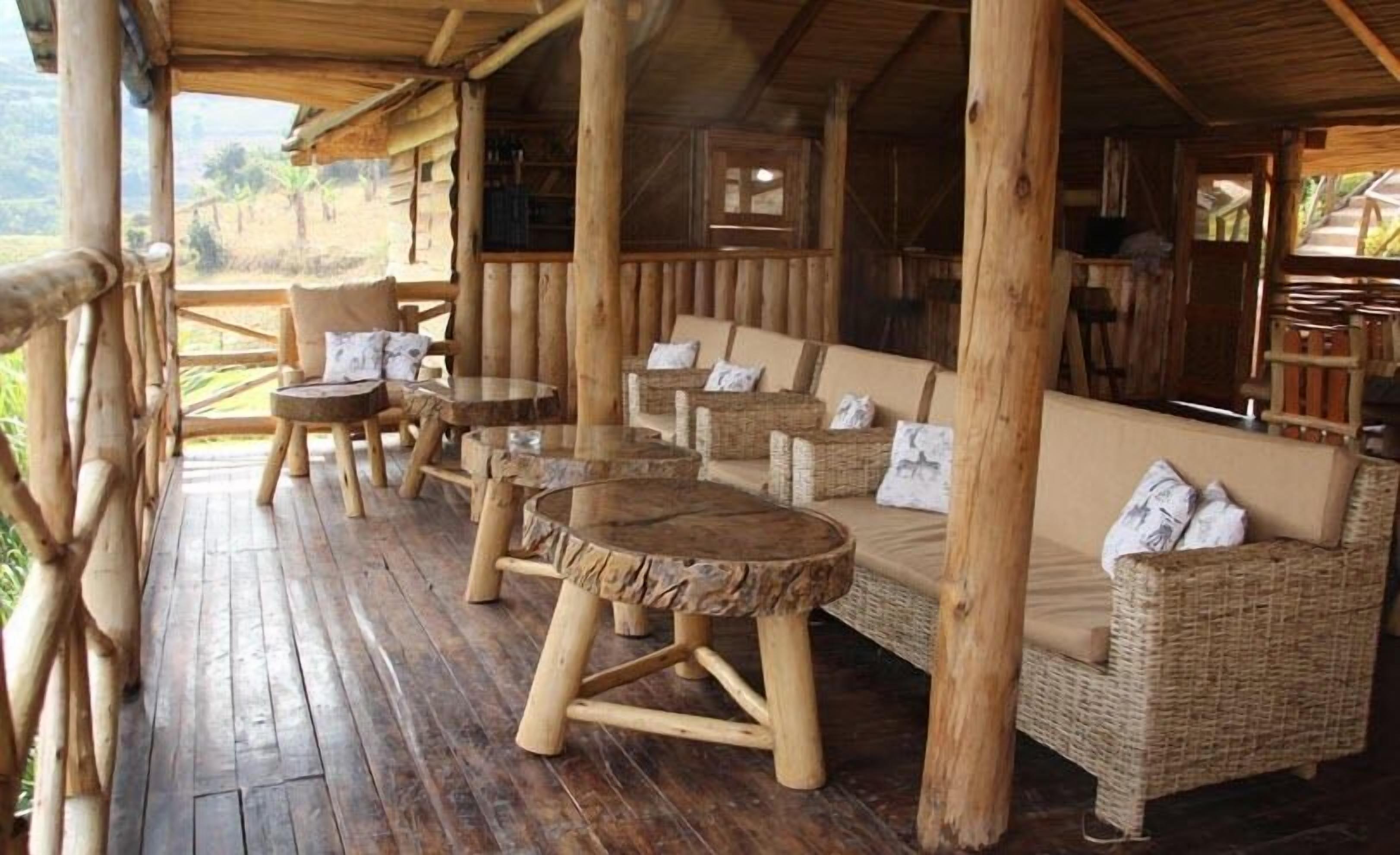 A wooden deck with wicker furniture and a covered area.
