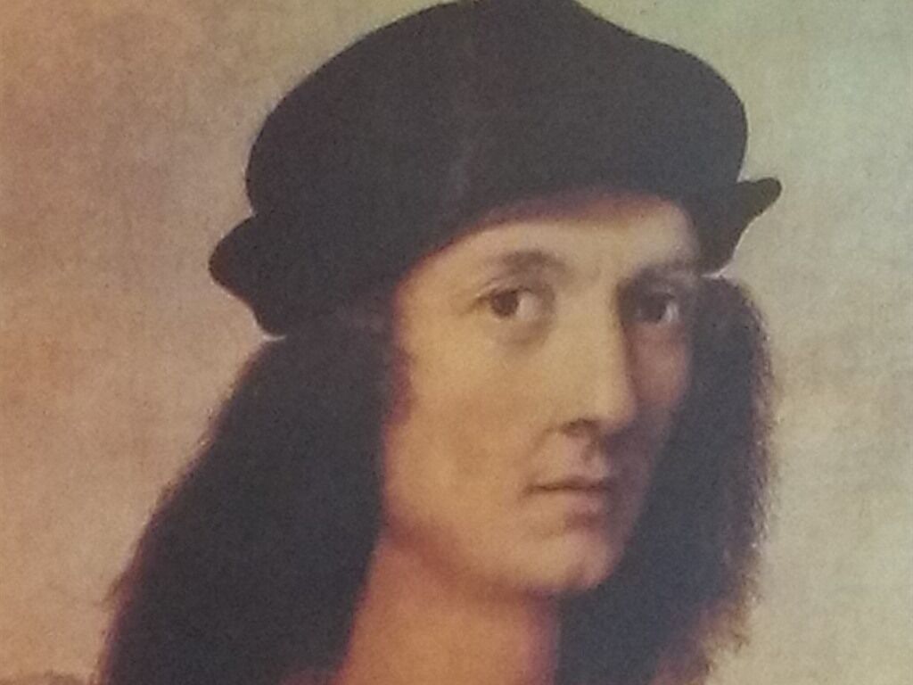 A portrait of a person wearing a hat.