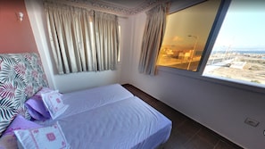 Apartment, 1 Bedroom, Sea View | 1 bedroom, bed sheets