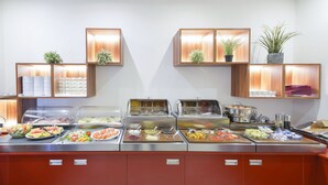 A buffet with various food items and a coffee station. - Hotel Garden Court (Prague)