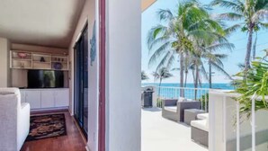 A balcony with a view of palm trees and the ocean. - Southwind by iTrip Palm Beach (Singer Island)