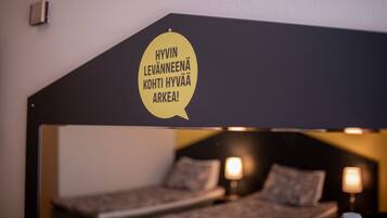 Sleep comfortably in this cozy room featuring a bunk bed with a unique headboard message.