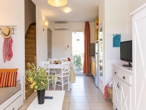 A compact living space with a dining area, kitchenette, and a television. - Sea-View holiday home in Northern Corsica (Belgodere)