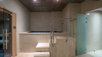 Stairs lead to a cozy recessed area with a glass door and grid-patterned ceiling.