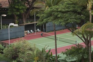 A tennis court with a seating area and surrounding greenery. - Mahana Resort #612 Studio Bedroom Condo by RedAwning (Lahaina)