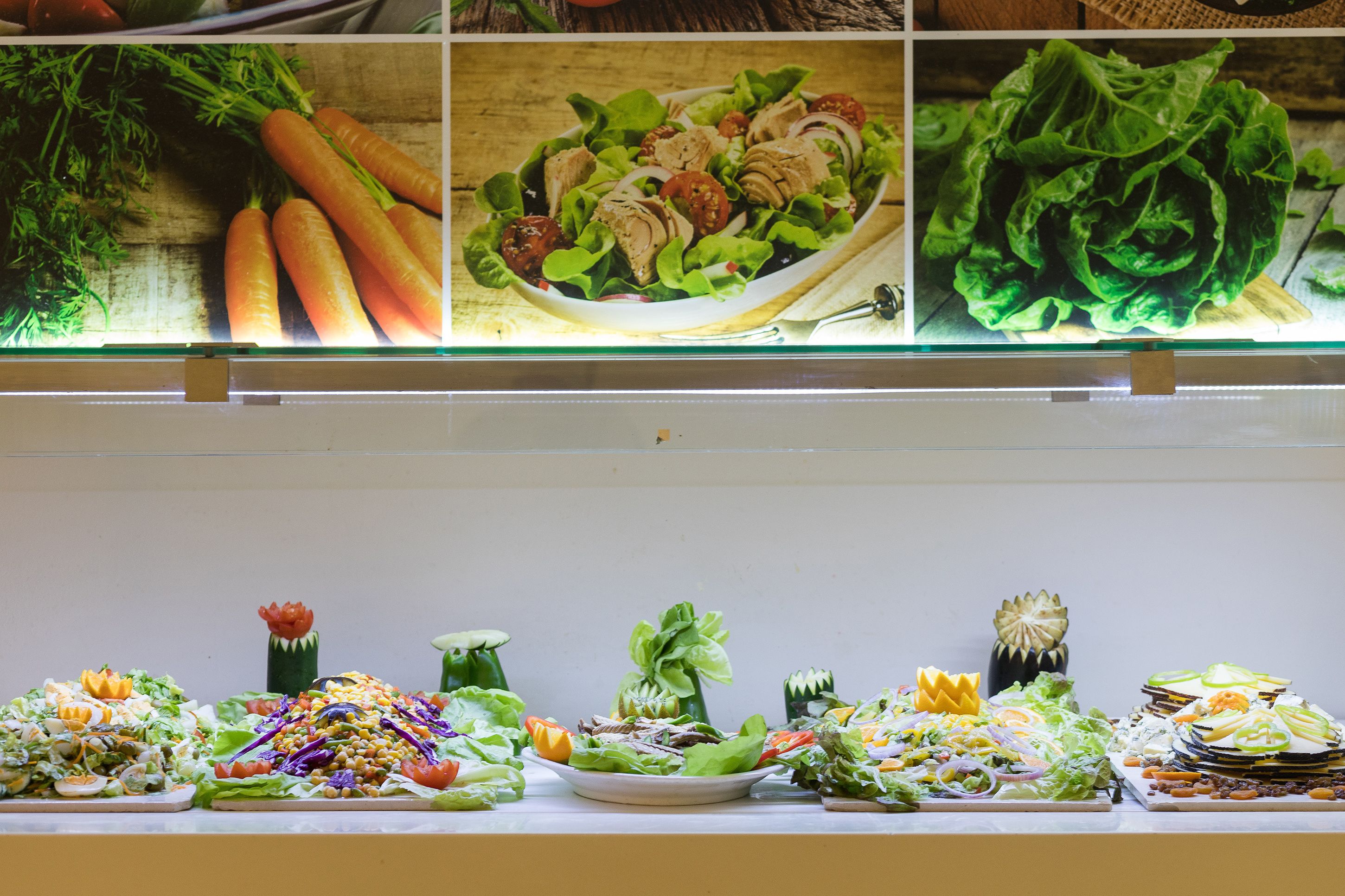 A buffet with various salads and vegetables.