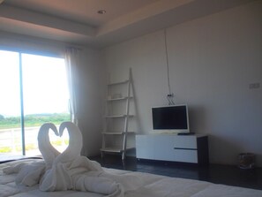 A bedroom with a large bed, a TV on a white cabinet, a ladder, and a view of the outdoors. - Aenguy Sabey Chiangkhan Homestay (Chiang Khan)
