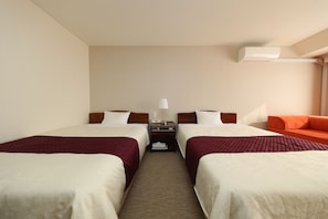 A hotel room with two beds, a nightstand, a lamp, an air conditioner, and a sofa. - Hotel 21 (Kusatsu)