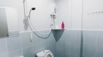 A bathroom with a sink, toilet, and shower.