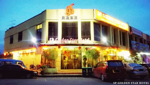 A hotel with a prominent swan logo, large windows, and a sign reading "Golden Star Hotel". - Sp Golden Star Hotel (Sungai Petani)