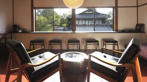A traditional Japanese room with tatami flooring, a low table, and six tatami mats arranged around it. - Kiraku Kyoto Higashiyama (Kyoto)