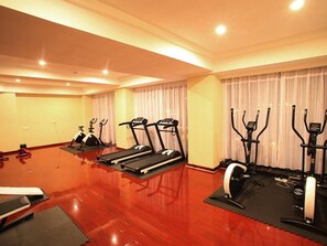 A gym with treadmills, elliptical machines, and a rowing machine. - Wanfangyuan Business Hotel (Beijing)