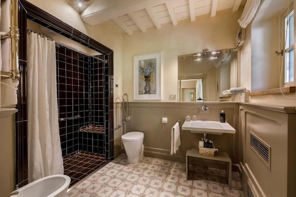A bathroom with a bathtub, a toilet, a sink, and a shower area. - Borgo Del Cabreo (Greve in Chianti)