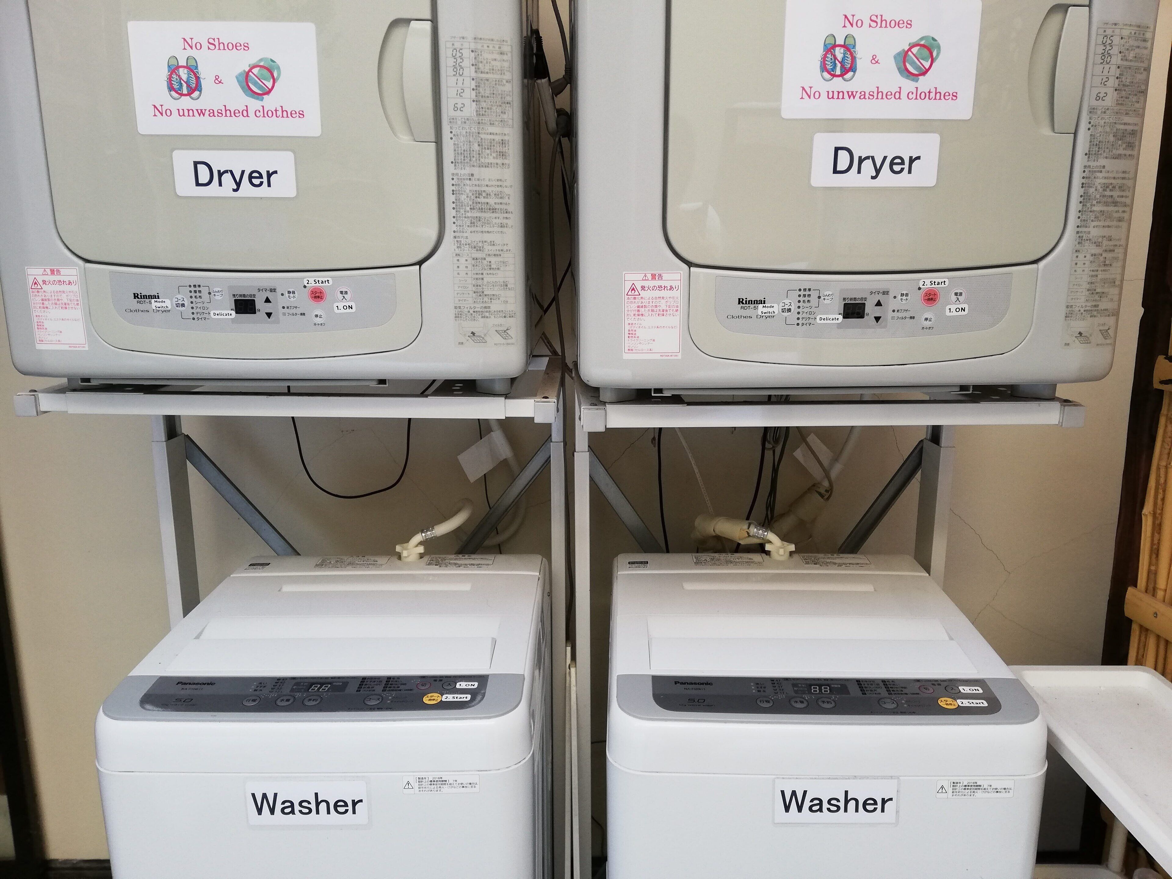 Two dryers and two washers in a laundry facility.