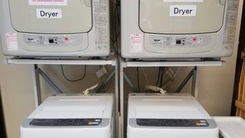 Two dryers and two washers in a laundry facility.