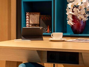 A wooden desk with a tablet, a white cup, and a book titled "HOME POINT". - My Bade Hotel (Istanbul)