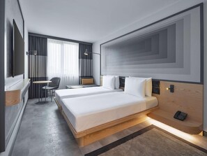A modern hotel room with two beds, a desk, and a chair. - My Bade Hotel (Istanbul)