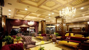 A spacious lobby with plush seating, a chandelier, and a reception desk. - My Bade Hotel (Istanbul)