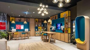 A modern hotel lobby with a reception desk, bar area, and seating. - My Bade Hotel (Istanbul)