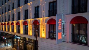 A hotel facade with arched windows, a prominent 'ibis' sign, and a glass entrance. - My Bade Hotel (Istanbul)