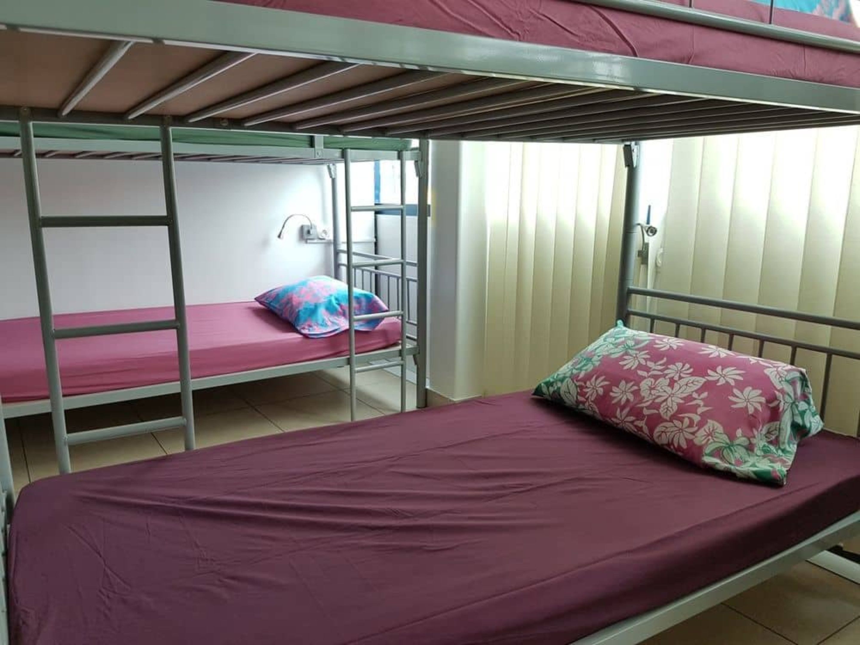 A bunk bed room with a single bed on the bottom bunk and a twin bed on the top bunk.