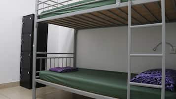 A bunk bed room with a desk and a filing cabinet.