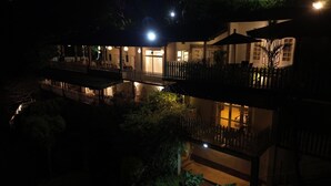 A multi-story building with balconies and outdoor seating areas, surrounded by greenery. - Villa Perpetua (Bandarawela)