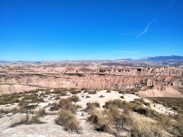A vast, rugged landscape with a clear sky.