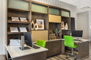 A modern office with two desks, computers, and green chairs. - Holiday Inn Knoxville N - Merchant Drive by IHG (Knoxville)