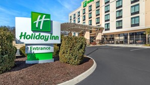 A Holiday Inn entrance sign and building facade. - Holiday Inn Knoxville N - Merchant Drive by IHG (Knoxville)