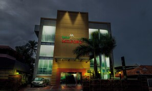 A modern hotel building with a prominent sign for 'hotel palmyra MILFORD'. - Treebo Premium Palmyra Milford, 2 Km From Alleppey Beach (Ambalapuzha)
