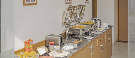 A breakfast buffet with various food items and a toaster.