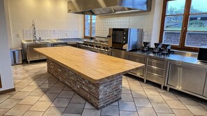 A modern kitchen with a central island, stainless steel appliances, and a large window. - Holiday Home in Somme-Leuze with Garden BBQ (Noiseux)