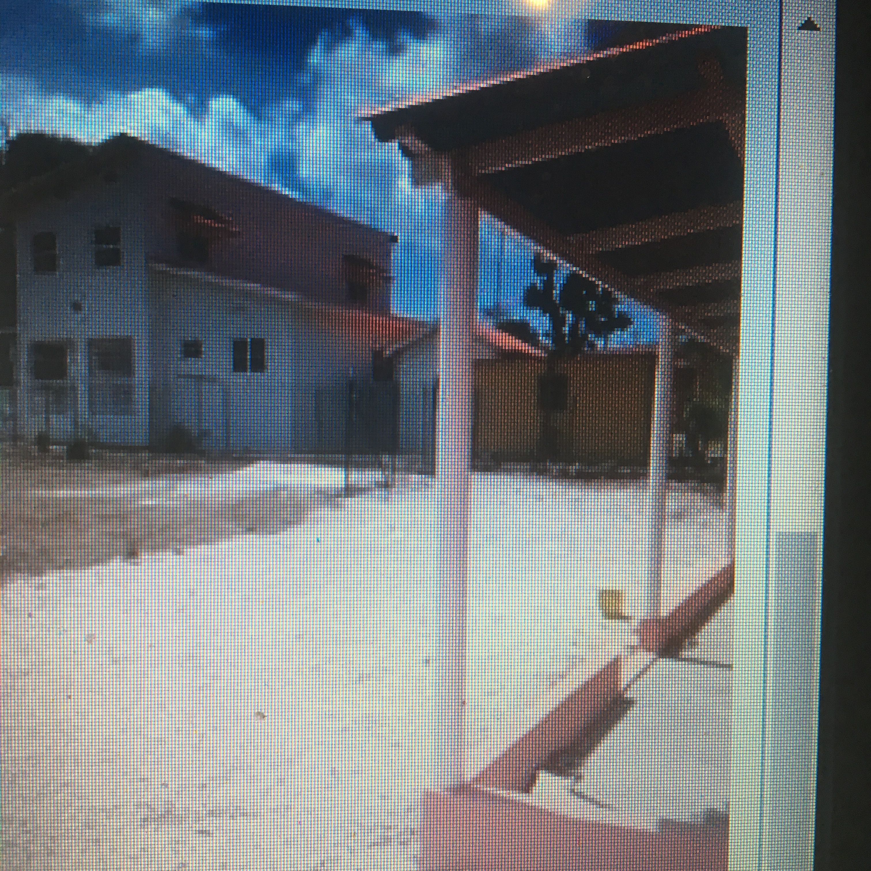 A building with a flat roof and a covered area with a roof.
