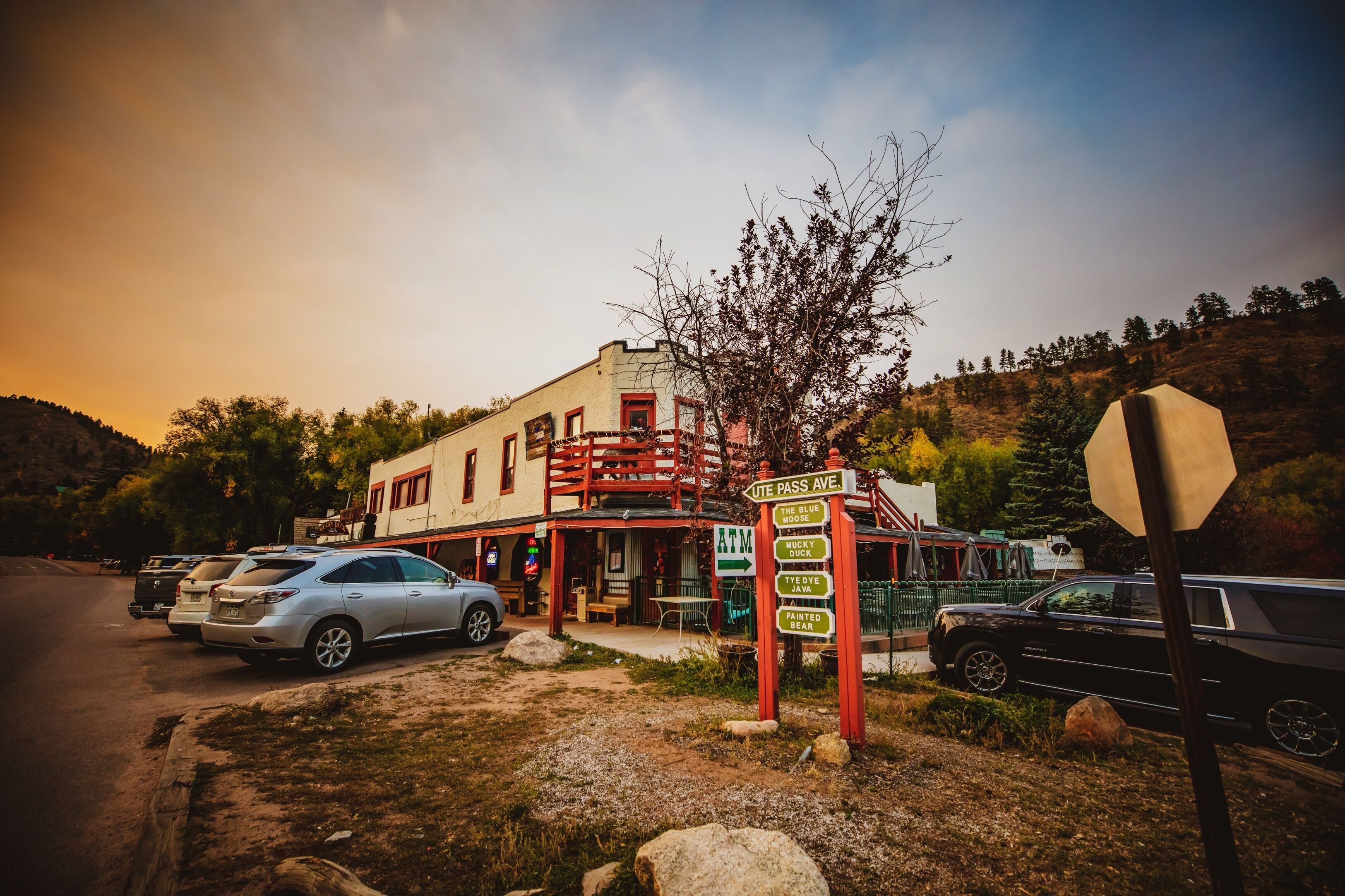A building with a signpost indicating directions to various locations.