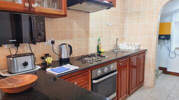 Apartment, Private Bathroom, Sea View (Two Bedroom Apartment) | Private kitchen | Fridge, microwave, oven, stovetop