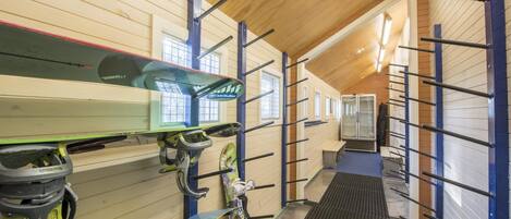 A ski rental facility with multiple ski racks and a covered seating area.