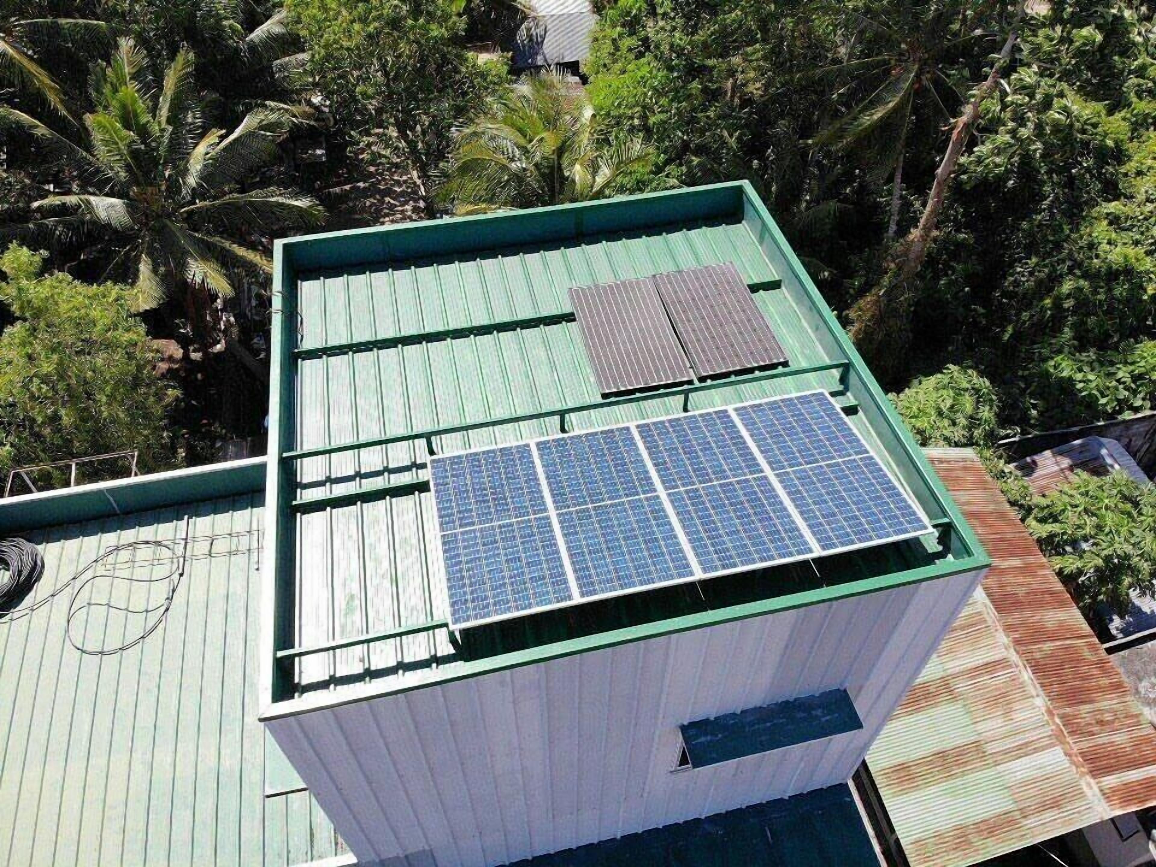 A building with a green roof and solar panels.