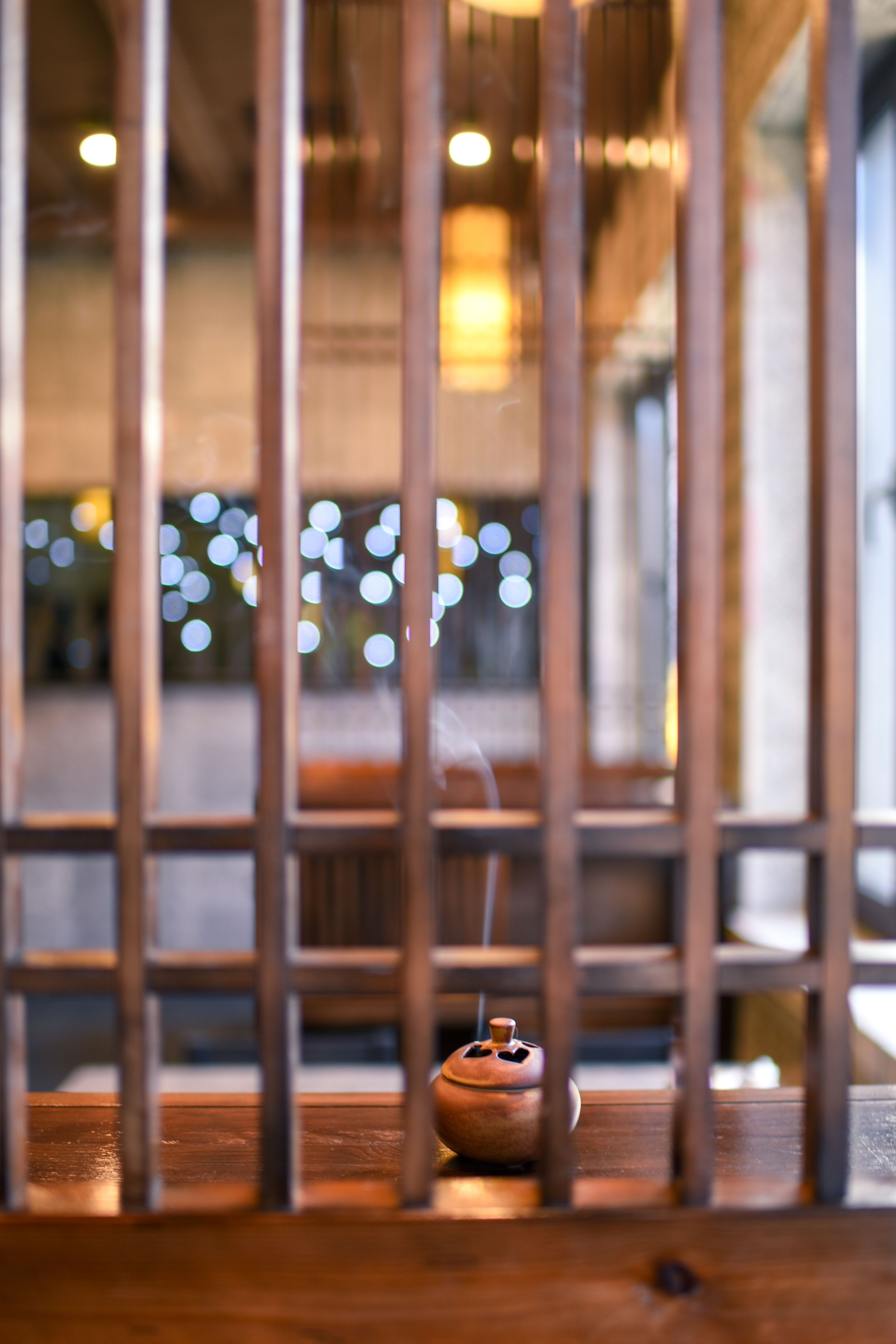 A wooden table with a small ceramic pot.