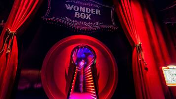 A theater entrance with a sign reading "WONDER BOX" and red curtains.