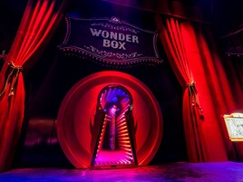 A theater entrance with a sign reading "WONDER BOX" and red curtains.