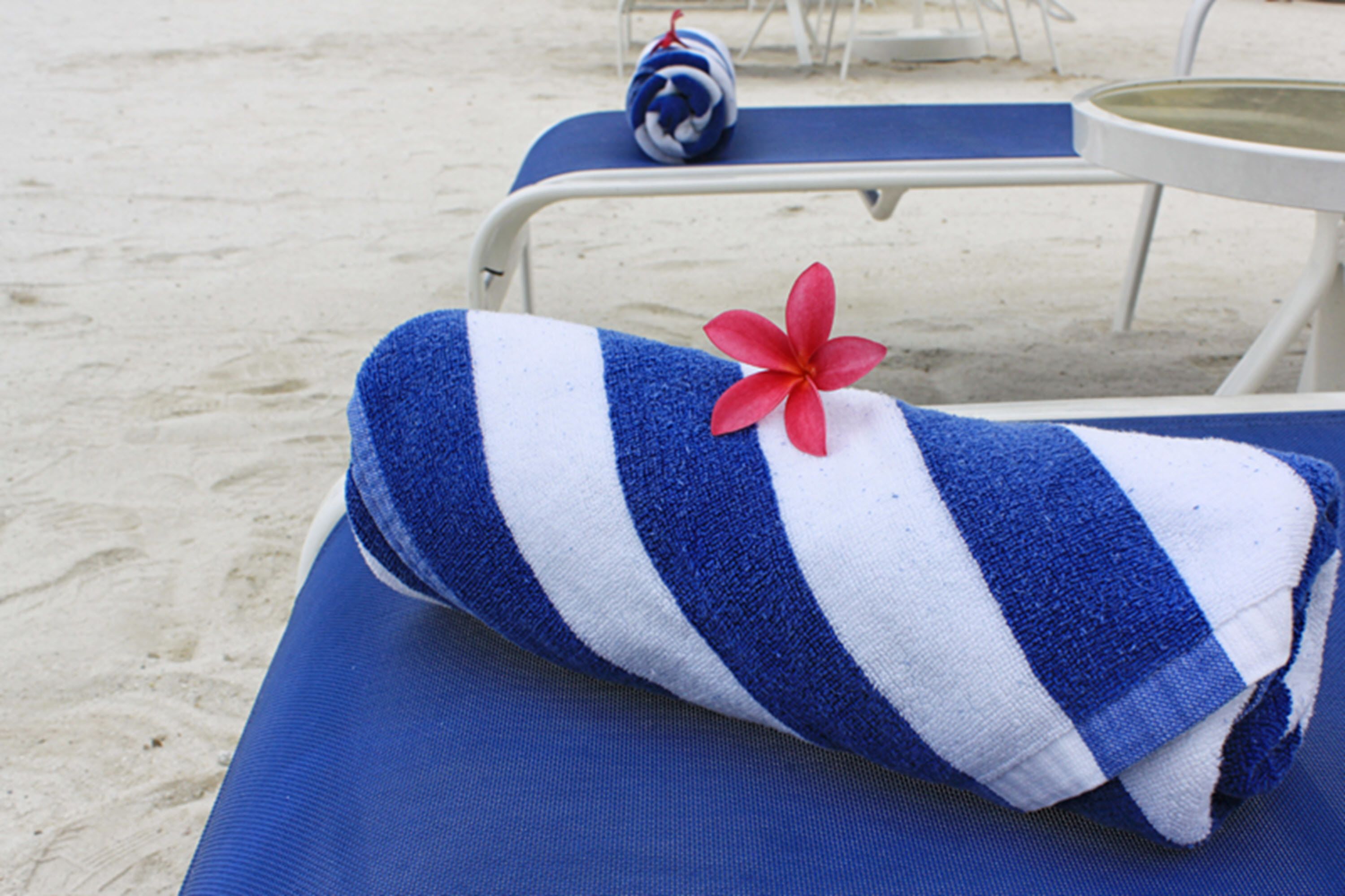 on the beach, white sand, beach umbrellas, beach towels