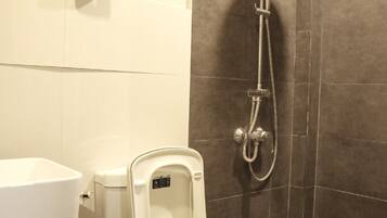 A modern bathroom with a toilet, bidet, and shower.