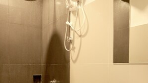 A bathroom with a shower, toilet, and sink.