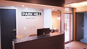 A reception desk with a sign reading "PARK HILL" and a phone number. - Hotel Park Hill Myeongdong (Seoul)