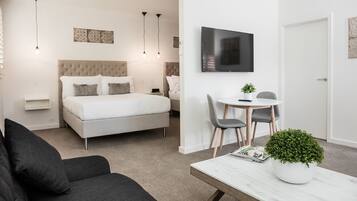 Studio Apartment Twin Queen | Living area | Flat-screen TV