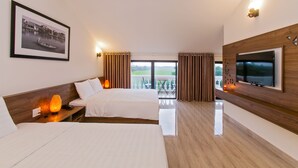 A hotel room with two beds, a TV, a framed picture, and a balcony with curtains. - Terrace Villa Hoi An (Da Nang)