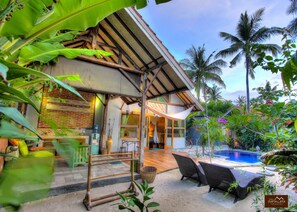 A tropical resort with a pool, bamboo furniture, and lush greenery. - Villa Samalama Gili Air (Gili Air)