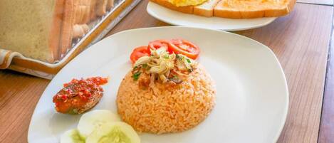 A breakfast buffet with various food items and utensils.