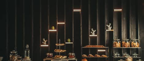 A buffet with various food items and glass jars.